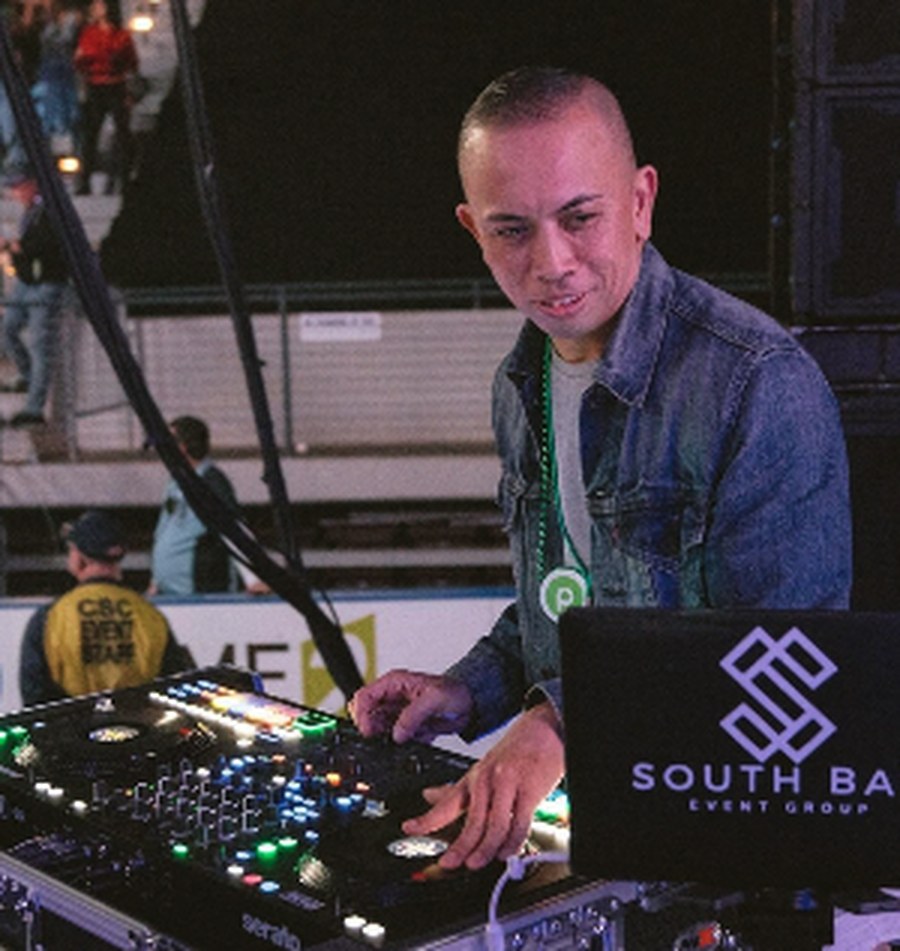 Albert Lao mixing behind a Southbay Event Group booth