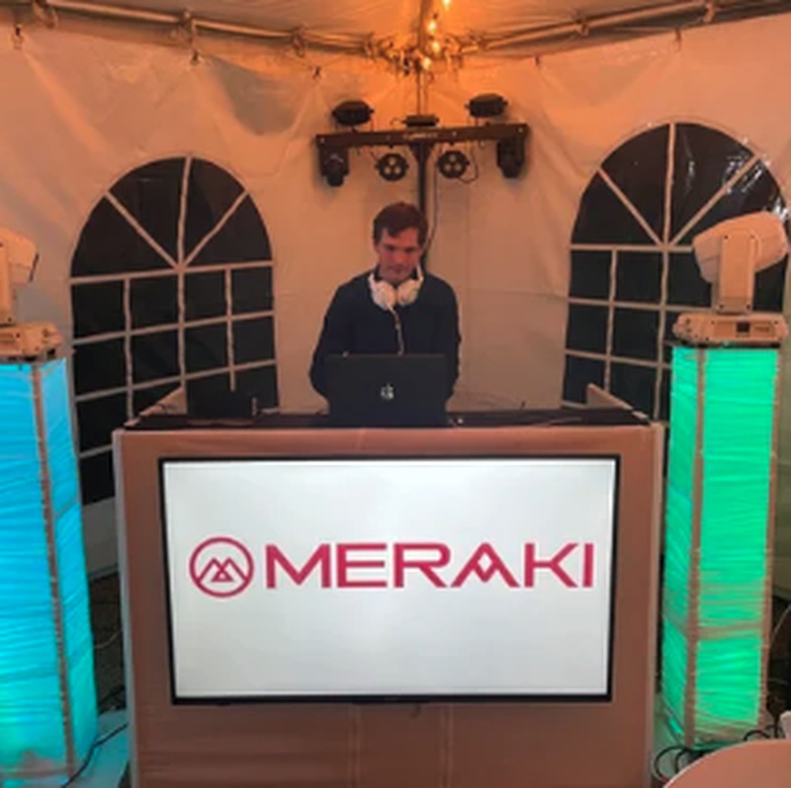 Branded Meraki DJ facade under a tent