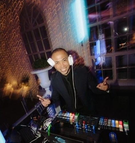DJ Mr. Lao behind the decks in headphones