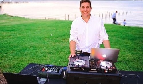 DJ Salty mixing at a waterfront event