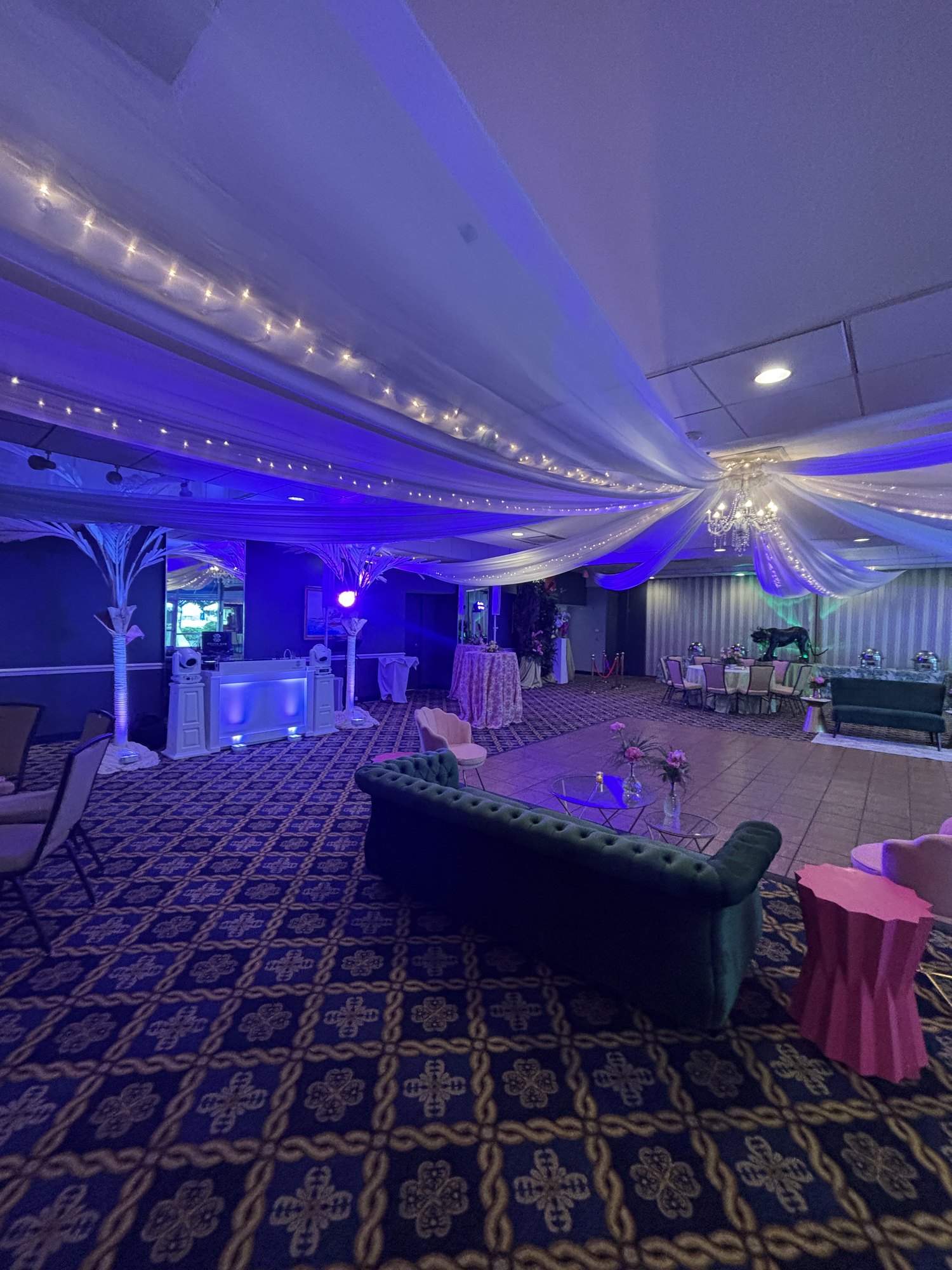 All-white DJ setup under draped ceiling lights at Pensacola Yacht Club