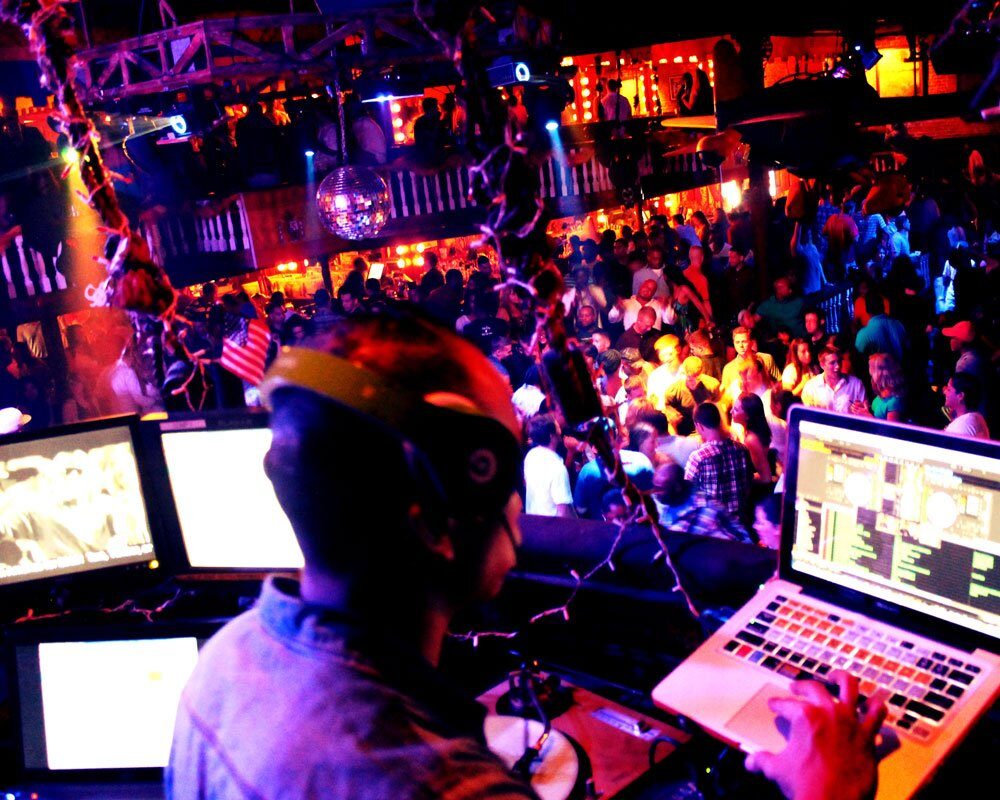 Nightclub-style booth with the crowd behind
